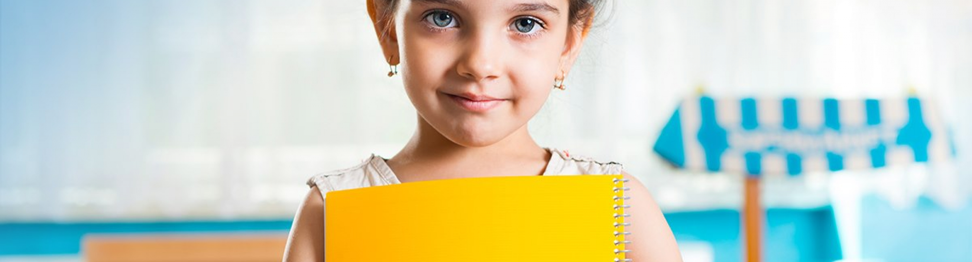 young student holding a yellow folder